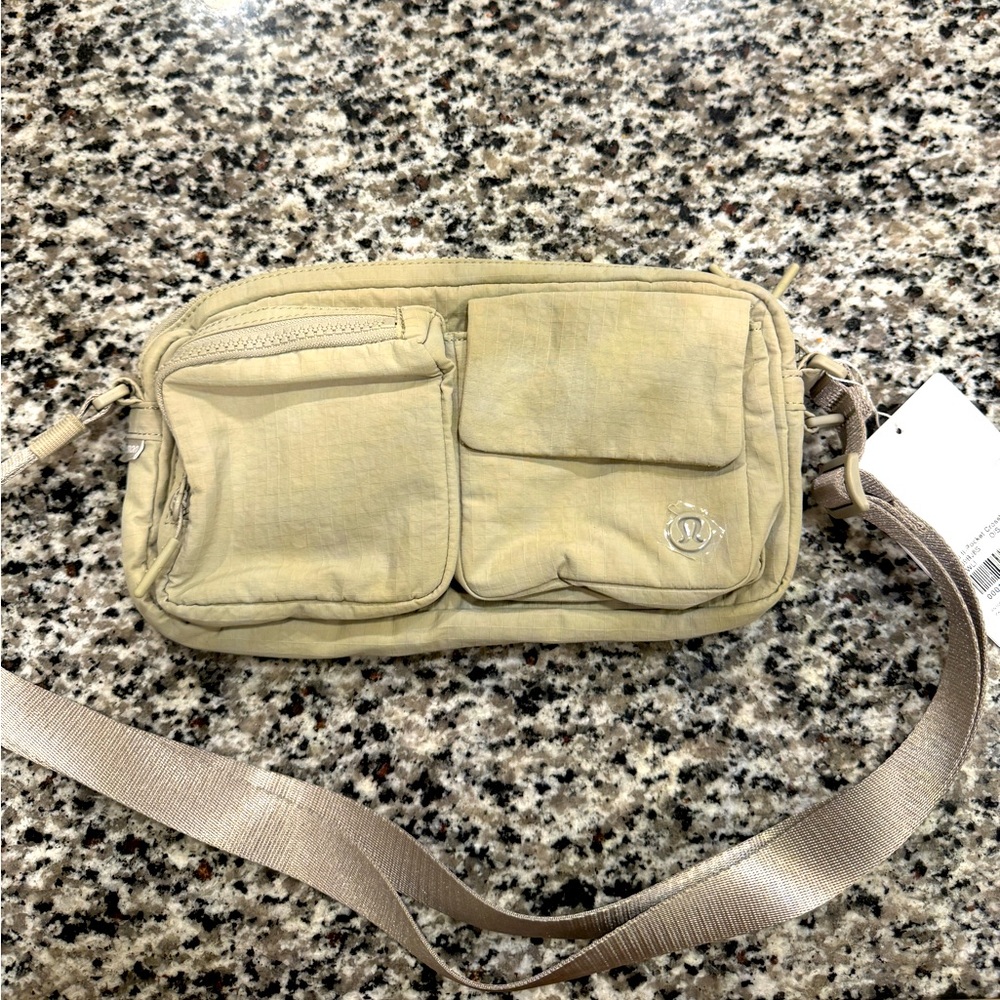 Brand new Lululemon tan crossbody belt bag with tags never removed.